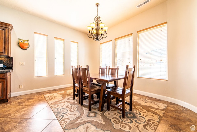 dining room with visible vents, baseboards, plenty of natural light, and an inviting chandelier