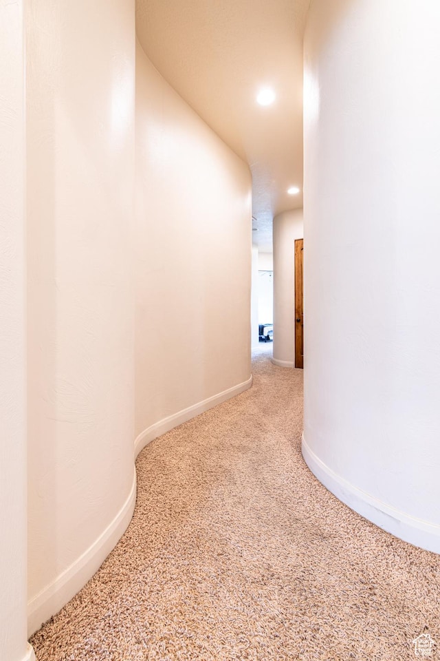 hall with recessed lighting, carpet, and baseboards