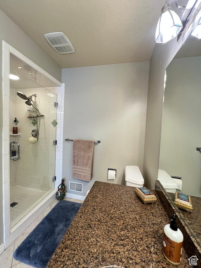 bathroom featuring a shower stall, tile patterned flooring, and visible vents