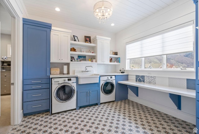 laundry area featuring a sink, a chandelier, recessed lighting, cabinet space, and light floors