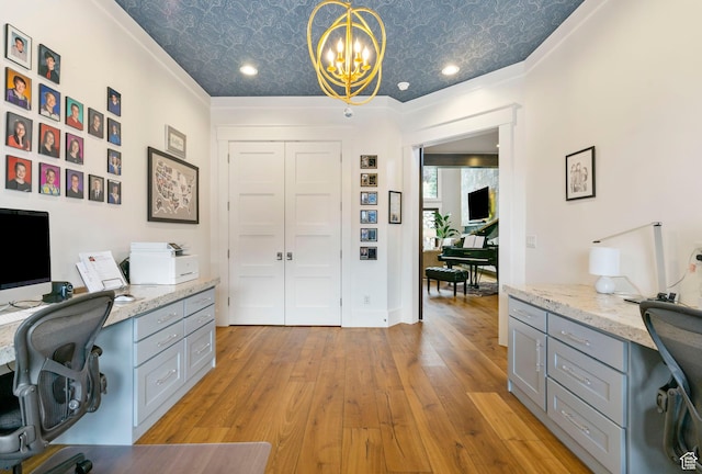 home office featuring an ornate ceiling, light wood finished floors, a notable chandelier, and built in desk