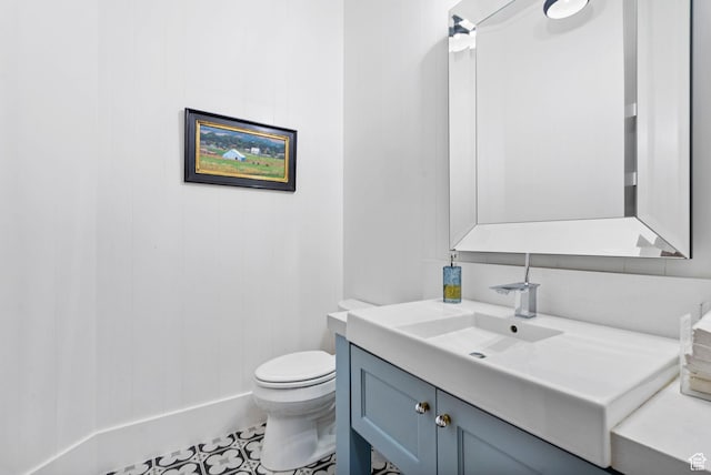 half bath featuring toilet and vanity