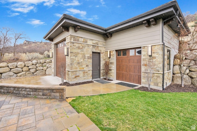 entrance to property with stone siding and a lawn