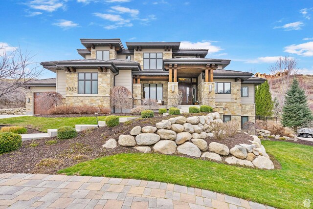 view of front of home with an attached garage and stone siding