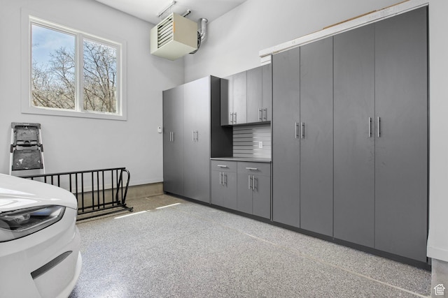 kitchen featuring gray cabinets, baseboards, and light speckled floor
