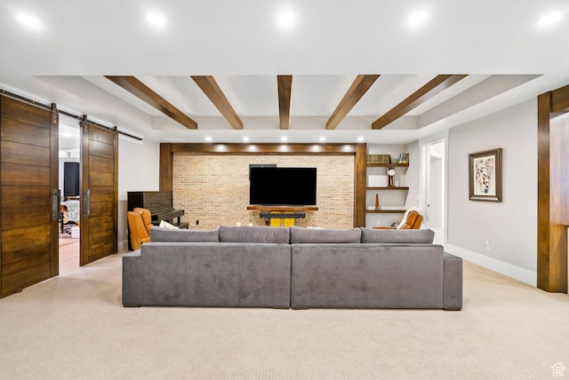 living area featuring light carpet, recessed lighting, beam ceiling, and a barn door