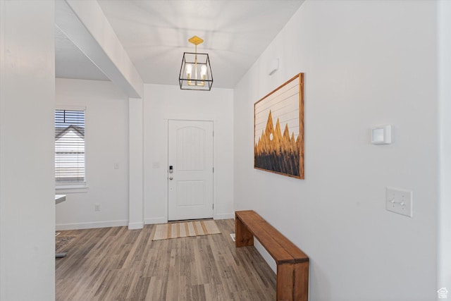 283 E Echo Ledge Dr S, Saratoga Springs, UT 84045 - foyer featuring light wood-style flooring, baseboards, and an inviting chandelier