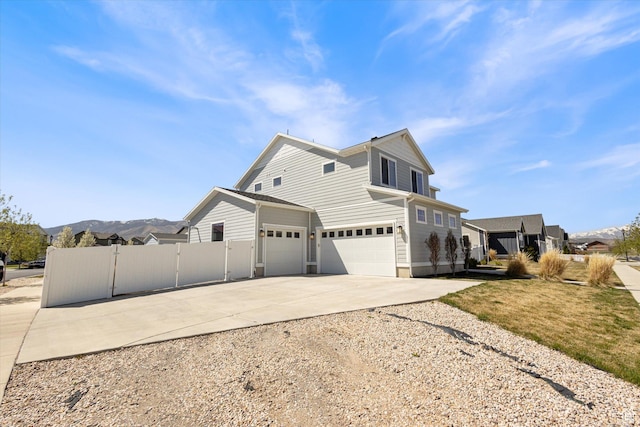 283 E Echo Ledge Dr S, Saratoga Springs, UT 84045 - view of property exterior with a mountain view, a gate, driveway, an attached garage, and fence