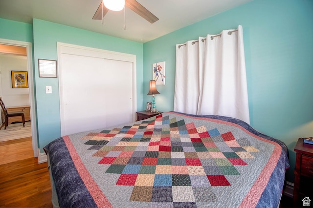 bedroom with ceiling fan, a closet, and wood finished floors