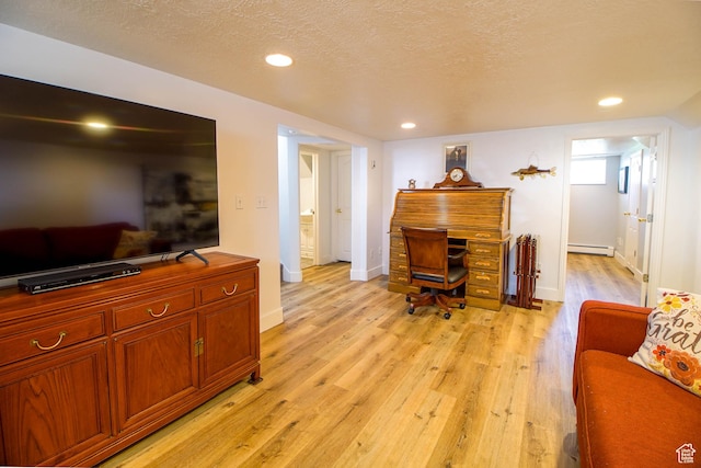 office space with recessed lighting, light wood-style flooring, a baseboard radiator, and baseboards