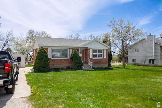 bungalow-style home with a shingled roof, a front yard, and brick siding