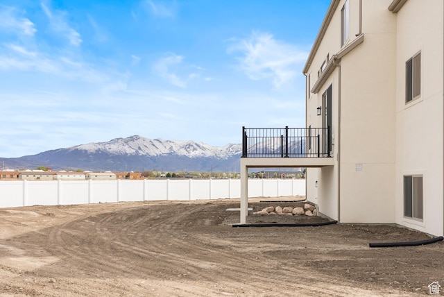 view of yard with a mountain view and fence