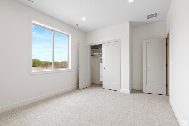 unfurnished bedroom featuring visible vents, baseboards, and carpet