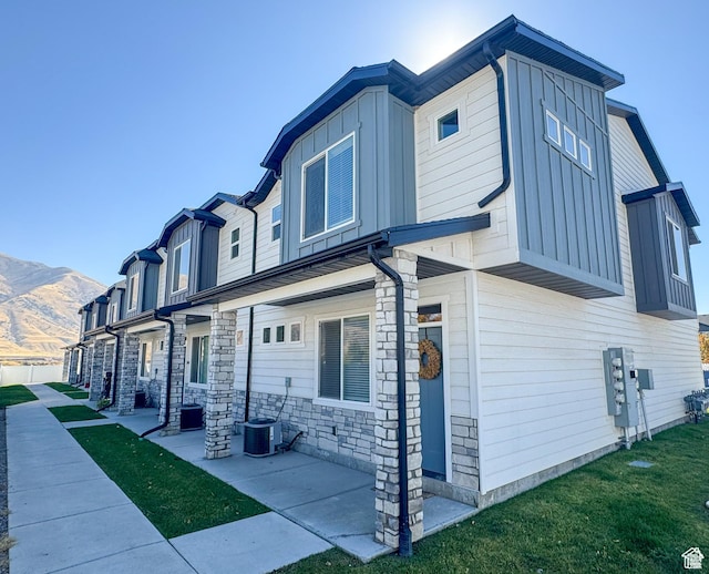 847 E 275 N Unit 847, Hyrum, UT 84319 - exterior space featuring cooling unit, board and batten siding, a mountain view, and stone siding