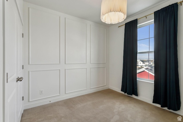 spare room with light carpet and plenty of natural light