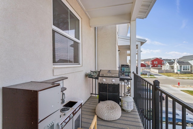 balcony with a residential view and area for grilling