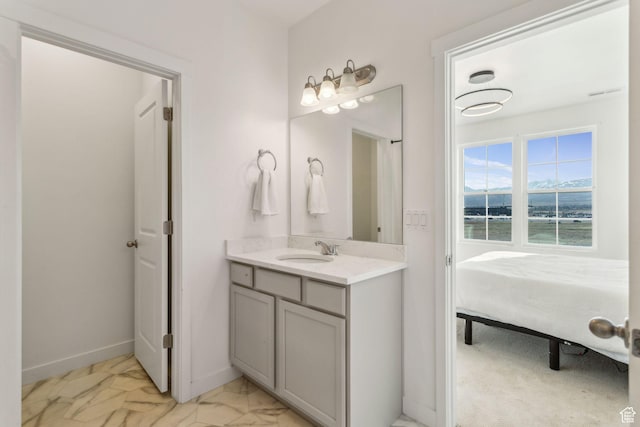 bathroom with a water view, baseboards, connected bathroom, and vanity