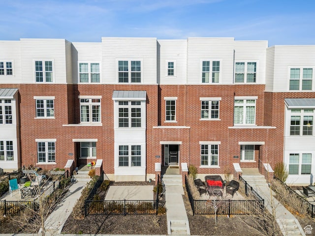 view of building exterior featuring a fenced front yard