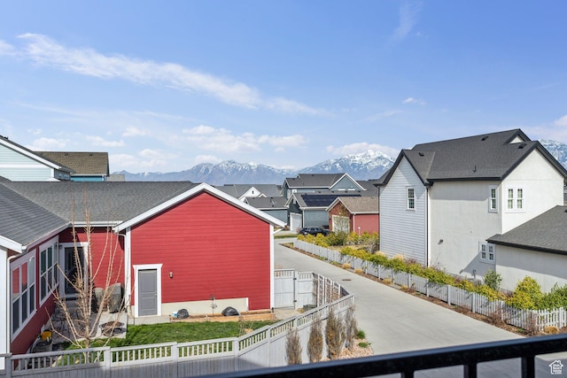 exterior space with a residential view, fence private yard, and a mountain view