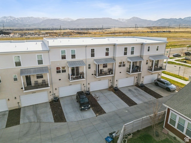 view of front of property featuring a mountain view, a garage, and stucco siding