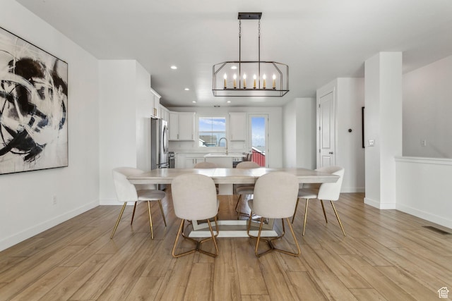 dining space with baseboards, light wood-type flooring, an inviting chandelier, recessed lighting, and visible vents