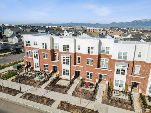 view of building exterior featuring a mountain view and a residential view