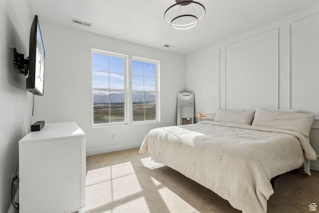 bedroom featuring light colored carpet, baseboards, and visible vents