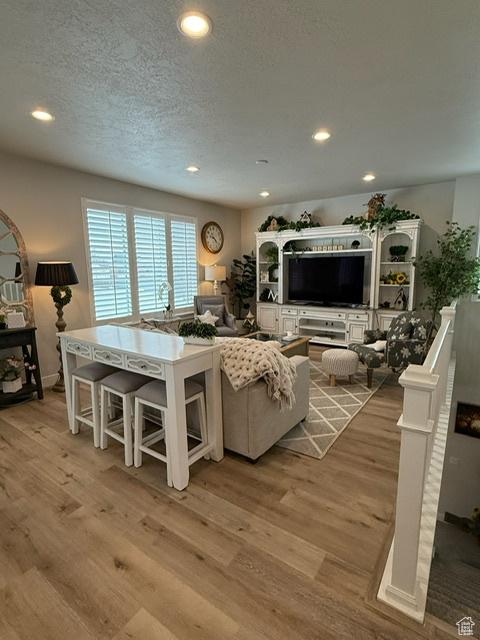 328 E 1100 S, Centerville, UT 84014 - living room featuring light wood-type flooring, recessed lighting, and a textured ceiling