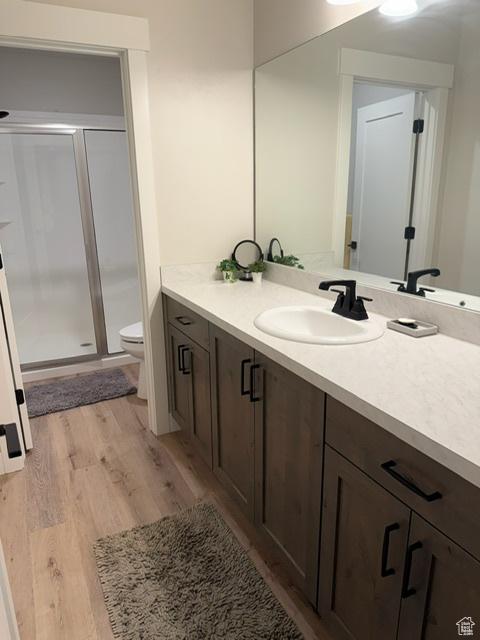 328 E 1100 S, Centerville, UT 84014 - bathroom with toilet, a stall shower, wood finished floors, and vanity