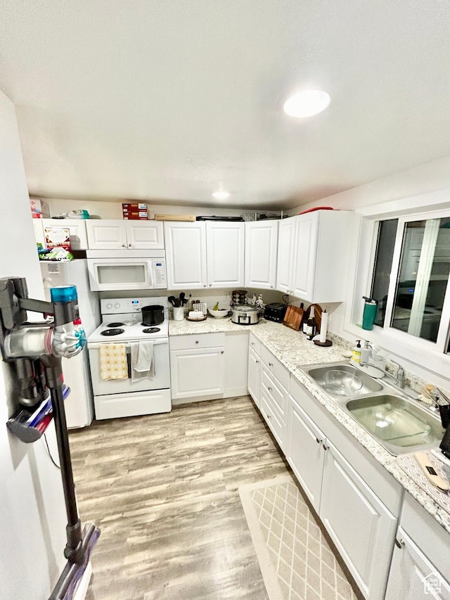 331 N 400 E, Logan, UT 84321 - kitchen featuring white appliances, light wood-style flooring, light countertops, white cabinets, and a sink
