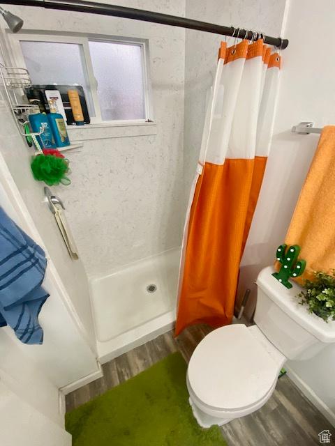 331 N 400 E, Logan, UT 84321 - full bath with a shower stall, wood finished floors, and toilet
