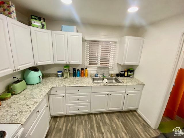 331 N 400 E, Logan, UT 84321 - kitchen with recessed lighting, white cabinetry, a sink, and wood finished floors