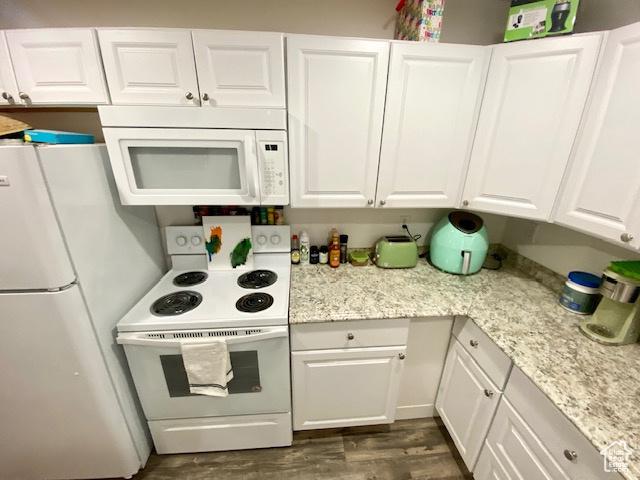 331 N 400 E, Logan, UT 84321 - kitchen featuring light stone countertops, white appliances, dark wood-style floors, and white cabinetry