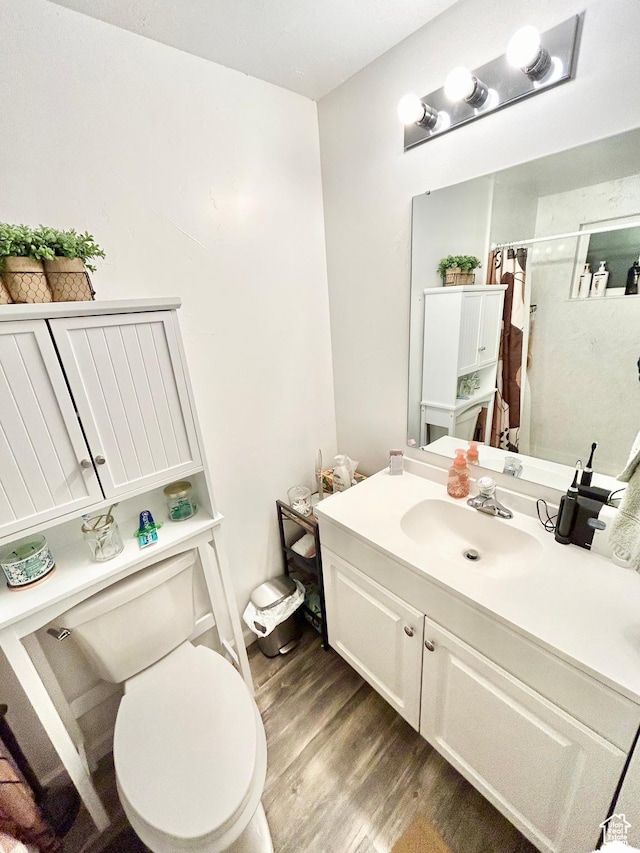 331 N 400 E, Logan, UT 84321 - bathroom featuring curtained shower, vanity, toilet, and wood finished floors
