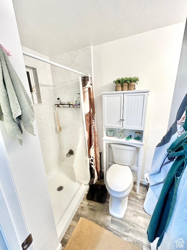 331 N 400 E, Logan, UT 84321 - full bath featuring a shower stall, toilet, and wood finished floors