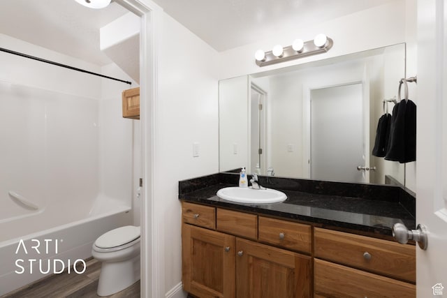 full bath featuring toilet, vanity, and washtub / shower combination