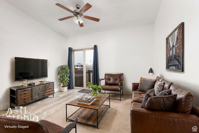 living area featuring wood finished floors and ceiling fan