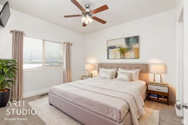 bedroom with baseboards, a ceiling fan, and light colored carpet