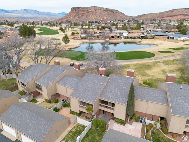 birds eye view of property featuring golf course view, a water and mountain view, and a residential view