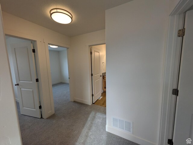 340 N 2650 W Unit 16, Tremonton, UT 84337 - corridor featuring light colored carpet, baseboards, and visible vents
