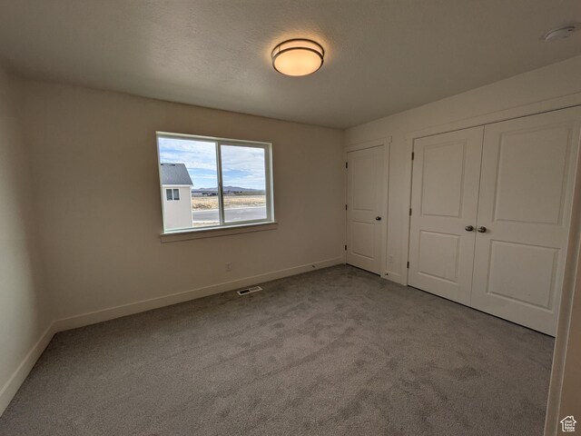 340 N 2650 W Unit 16, Tremonton, UT 84337 - unfurnished bedroom featuring a closet, carpet flooring, visible vents, and baseboards