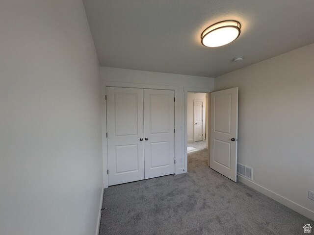 340 N 2650 W Unit 16, Tremonton, UT 84337 - unfurnished bedroom with a closet, baseboards, visible vents, and carpet floors