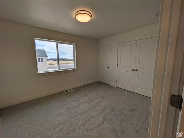 340 N 2650 W Unit 16, Tremonton, UT 84337 - unfurnished bedroom with a closet, baseboards, visible vents, and carpet floors