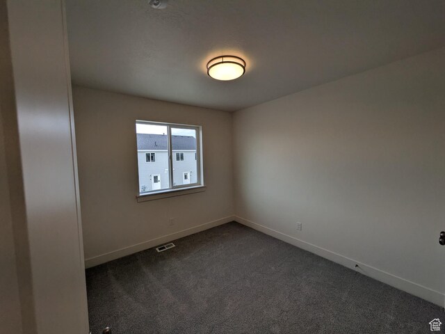 340 N 2650 W Unit 16, Tremonton, UT 84337 - spare room featuring visible vents, baseboards, and dark colored carpet