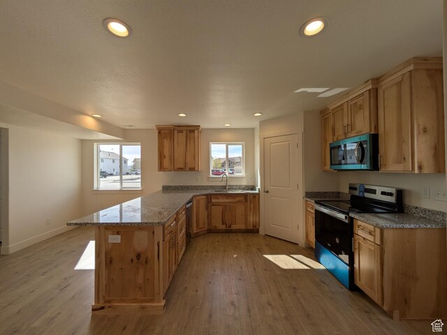 340 N 2650 W Unit 16, Tremonton, UT 84337 - kitchen with a sink, light wood finished floors, a peninsula, and stainless steel appliances