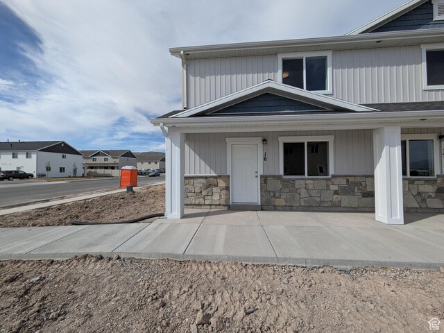 340 N 2650 W Unit 16, Tremonton, UT 84337 - exterior space with stone siding and covered porch