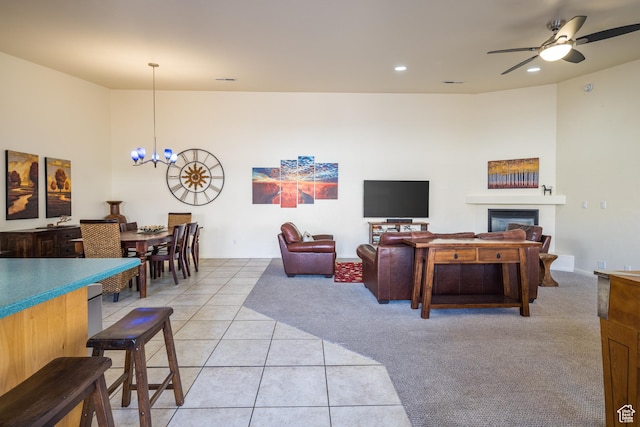 327 W Williams Way, Moab, UT 84532 - living room with a glass covered fireplace, light carpet, recessed lighting, ceiling fan with notable chandelier, and light tile patterned floors