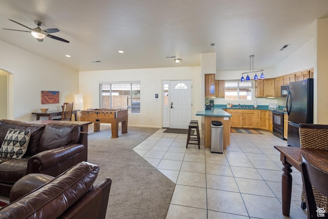 327 W Williams Way, Moab, UT 84532 - living area featuring a ceiling fan, light colored carpet, plenty of natural light, and light tile patterned floors