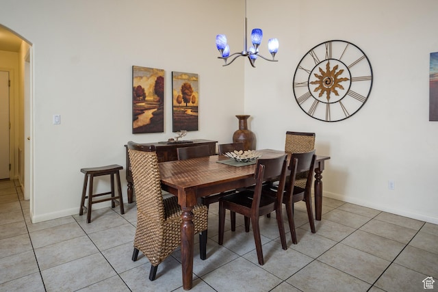 327 W Williams Way, Moab, UT 84532 - dining area with light tile patterned floors, arched walkways, an inviting chandelier, and baseboards