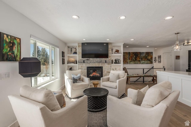 528 W Weber Canyon Rd, Oakley, UT 84055 - living area featuring recessed lighting, wood finished floors, a fireplace, baseboards, and built in shelves